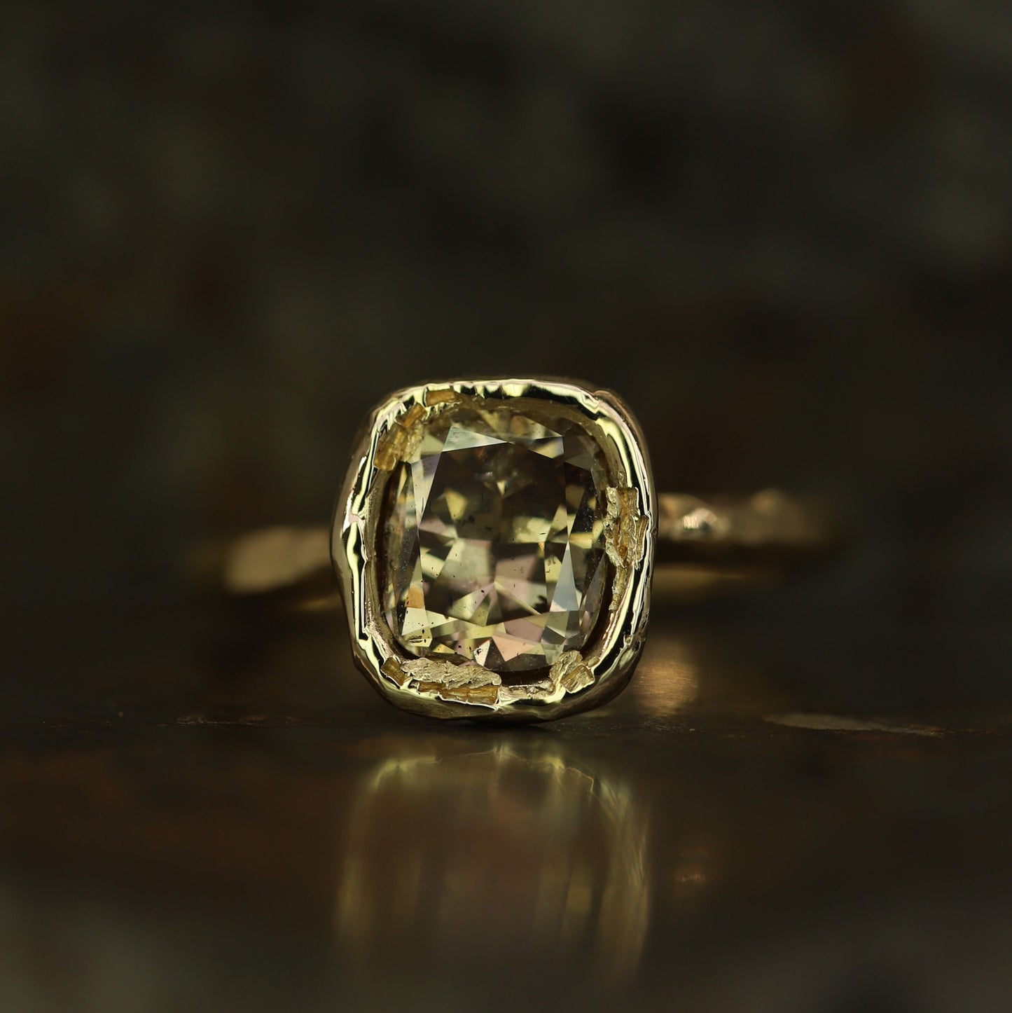 Ellis Mhairi Cameron - Gold ring with a large diamond on a dark background