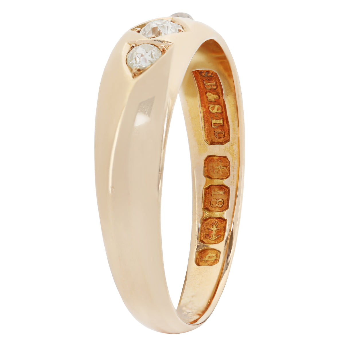 A yellow gold ring with a diagonal split design, featuring two round-cut clear gemstones on the top and a series of gold hallmark stamps on the inner band, shown against a plain white background.