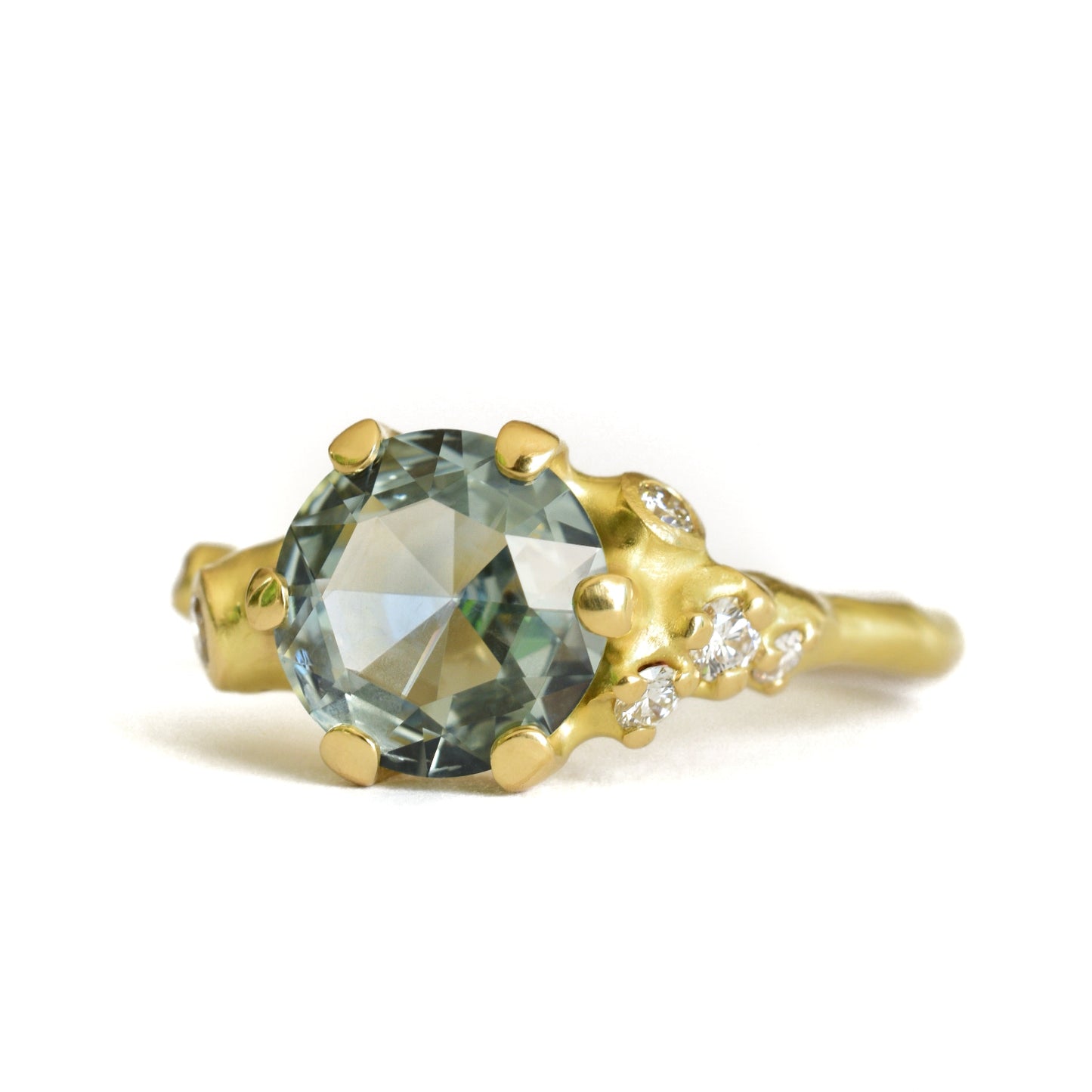 Johnny Ninos Gold ring with a green gemstone on a white background