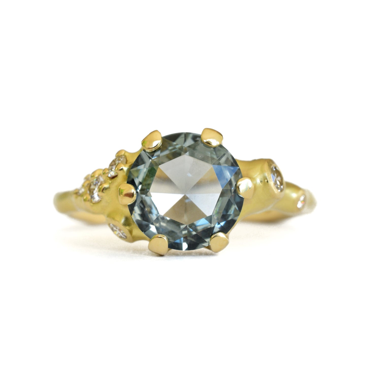 Johnny Ninos Gold ring with a large green gemstone on a white background