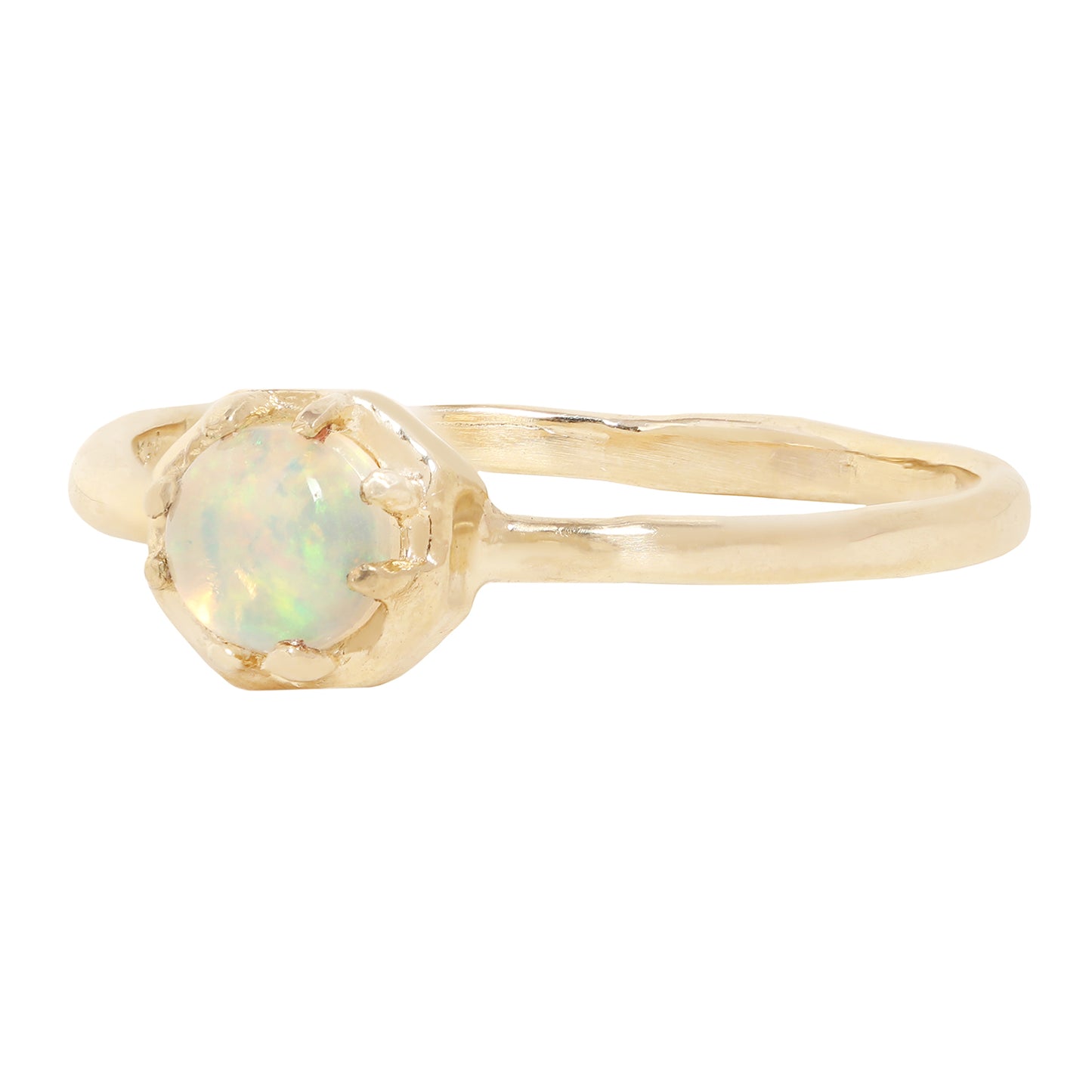 A gold ring featuring a round iridescent opal gemstone in a textured prong octagon setting, shown against a plain white background.
