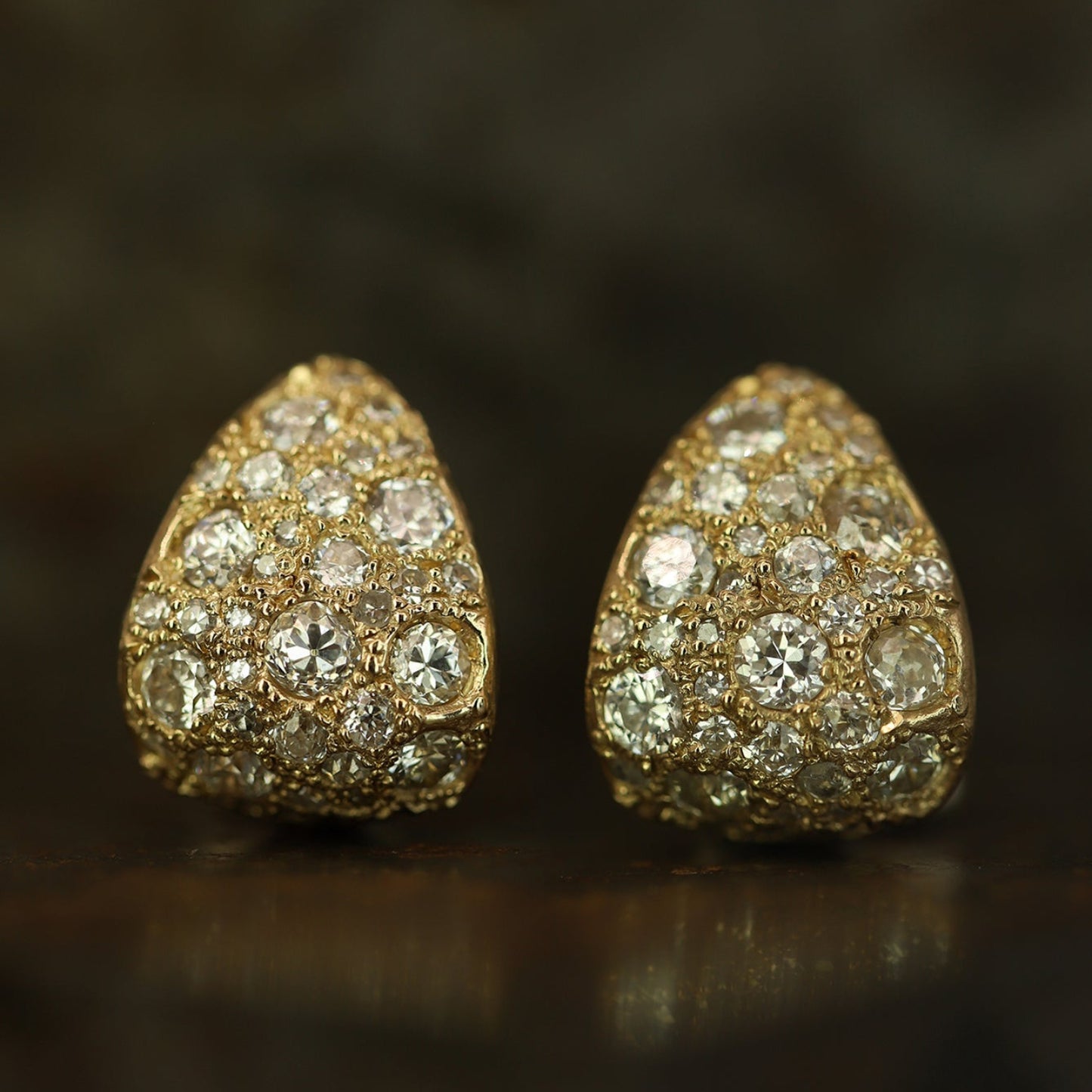 Ellis Mhairi Cameron - Pair of gold earrings with diamond accents on a dark background