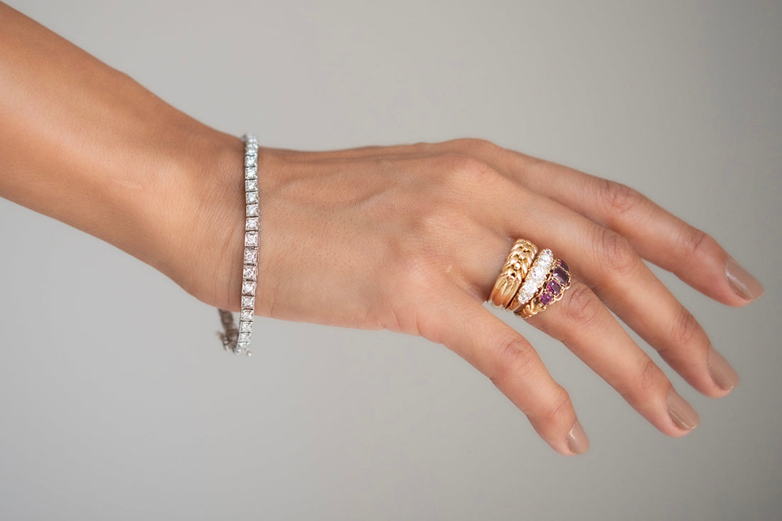 Antique Engagement Rings and tennis bracelet on modal hand