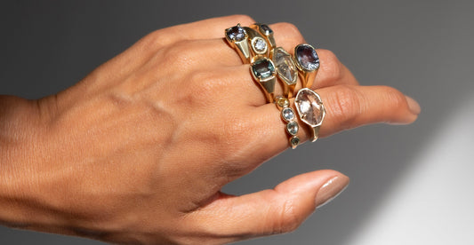 sapphire and diamond rings shown on hand model