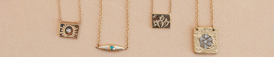 Aili necklaces on beige background