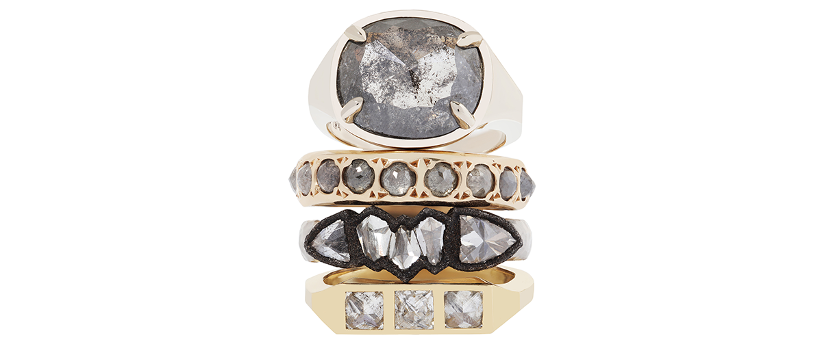 stack of four diamond and gold rings