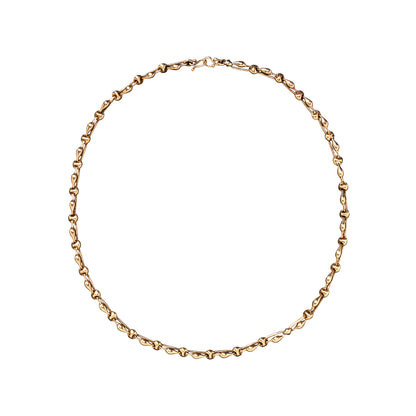 A delicate yellow gold chain necklace with a small clasp, arranged in a circle on a solid white background.