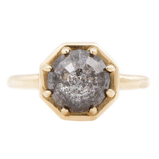 Gold ring with a gray diamond on a white background