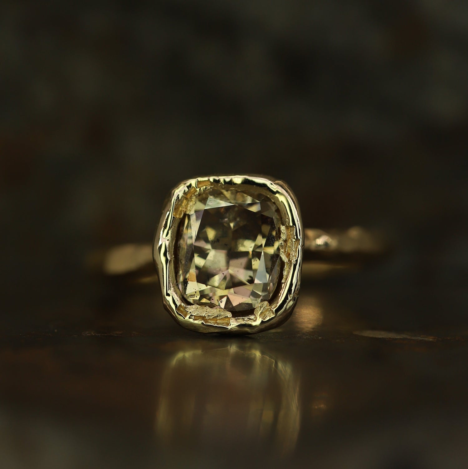 Ellis Mhairi Cameron - Gold ring with a large diamond on a dark background