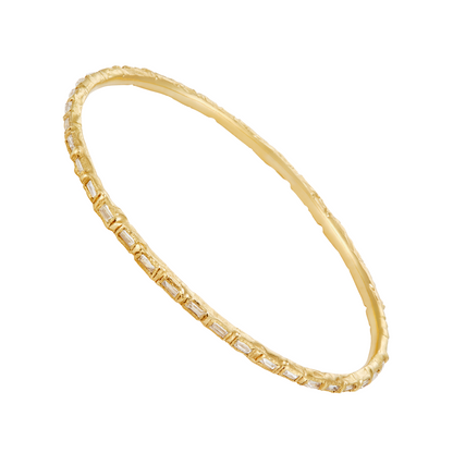 A gold bangle bracelet featuring a textured outer band and a smooth inner band paved with small rectangular clear stones, shown on a plain white background.
