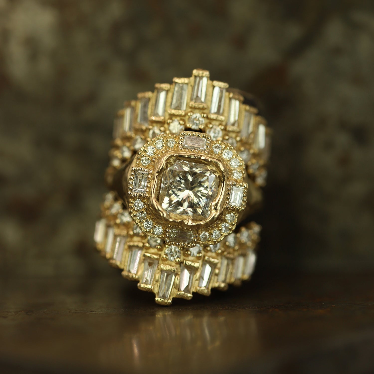Ellis Mhairi Cameron - Gold ring with diamond accents on a dark background