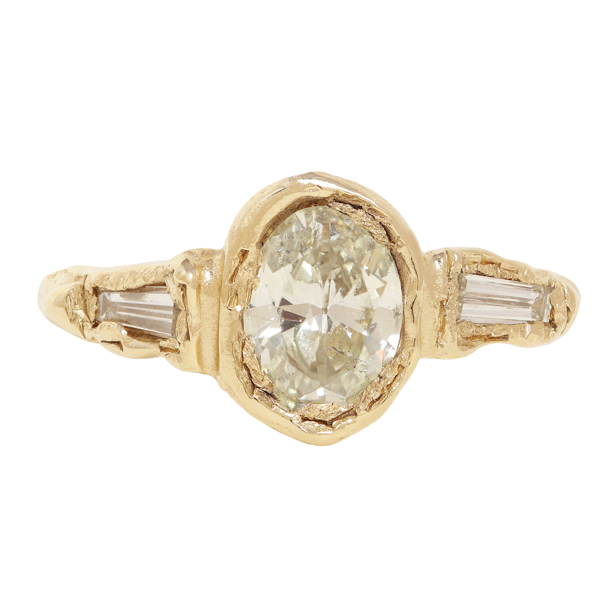 A yellow gold ring featuring a large oval-cut clear center stone and two baguette-cut side stones, shown on a plain white background.