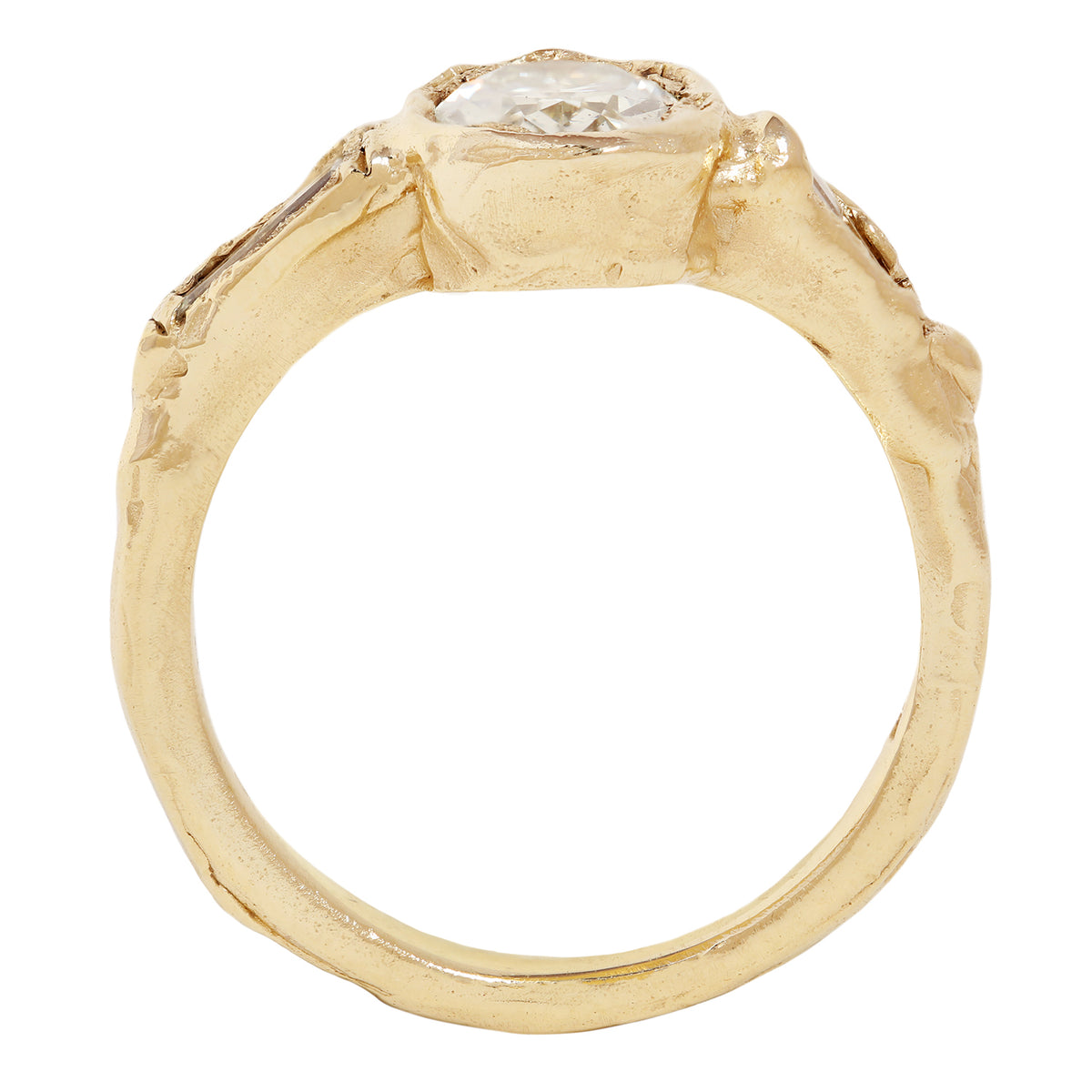 A yellow gold ring featuring a large oval-cut clear center stone and two baguette-cut side stones, shown on a plain white background.