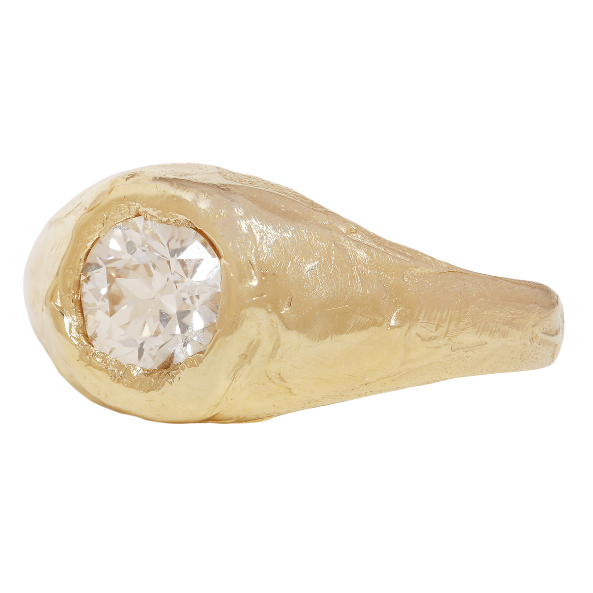 A textured gold signet-style ring featuring a large, round brilliant-cut diamond center stone, shown against a plain white background.
