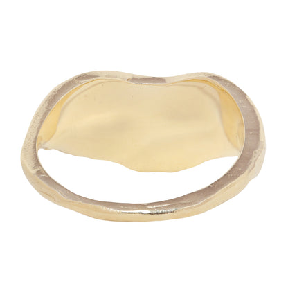A gold ring featuring a wavy, organic shape with multiple baguette-cut clear diamonds set across the top, shown against a plain white background.