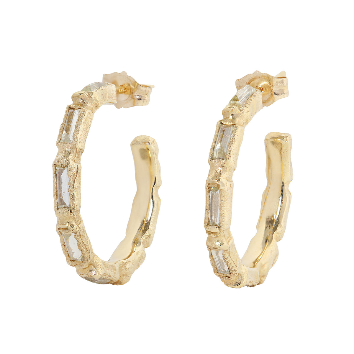 Textured gold and diamond hood earring on white background