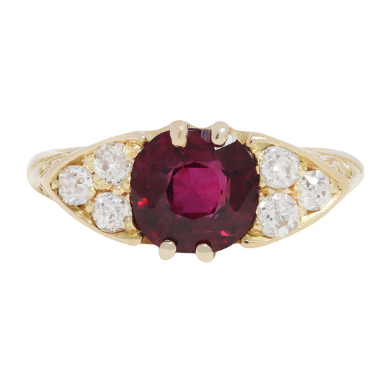 Antique Gold ring with a red ruby and diamond accents on a white background