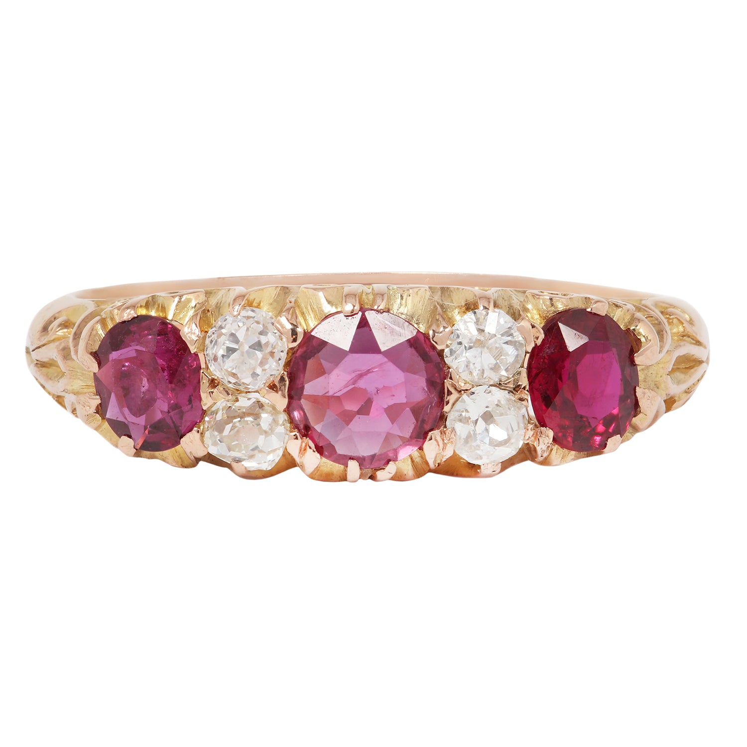 Gold ring with pink and red gemstones on a white background