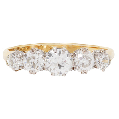 Gold ring with five diamonds on a white background