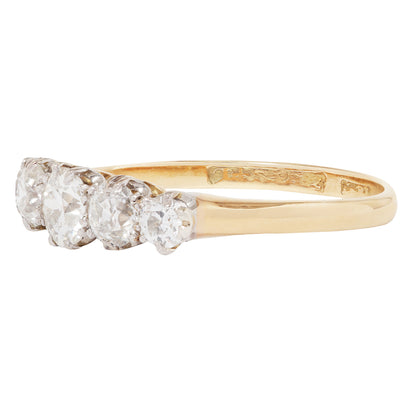 Gold ring with three diamonds on a white background
