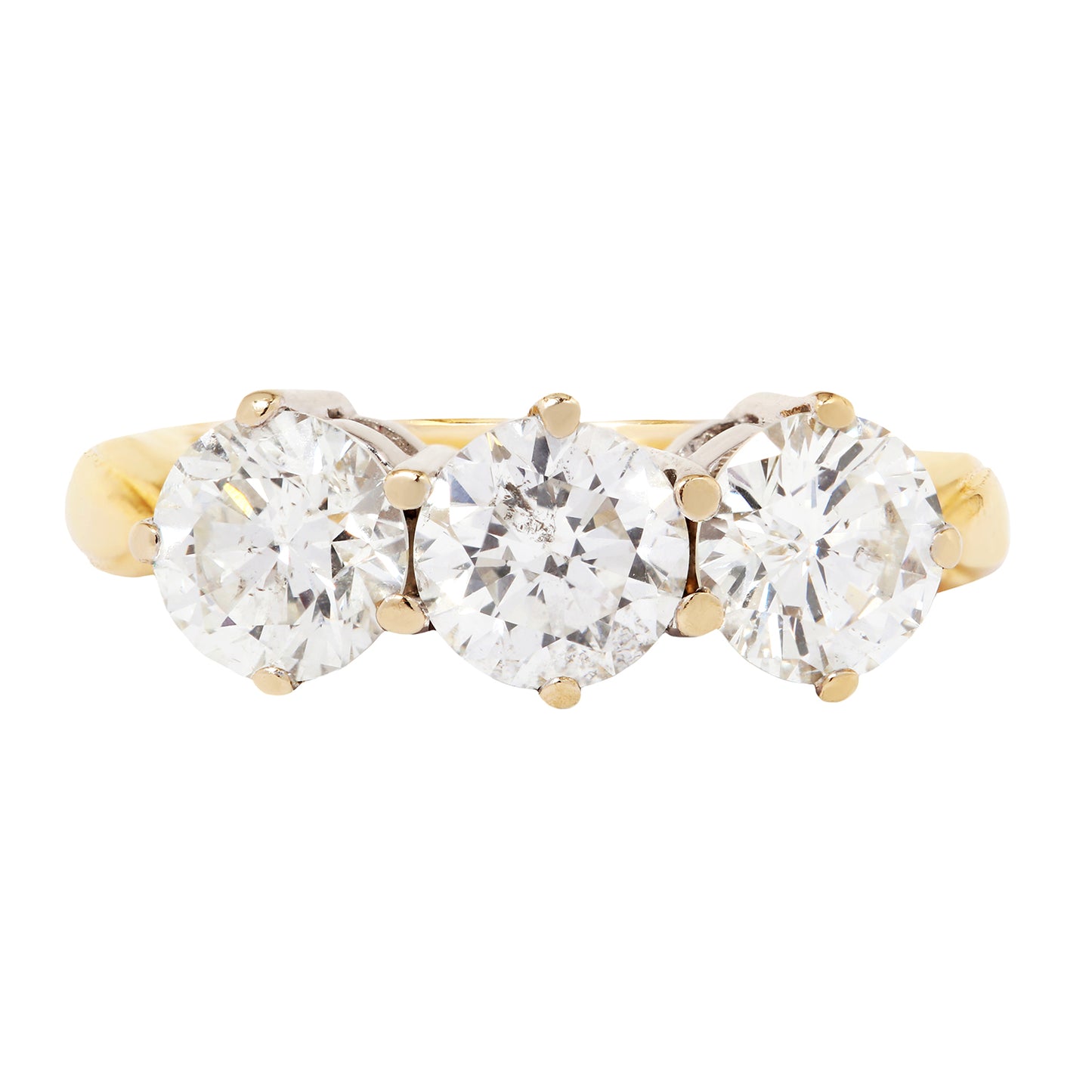 Gold ring with three clear gemstones on a white background