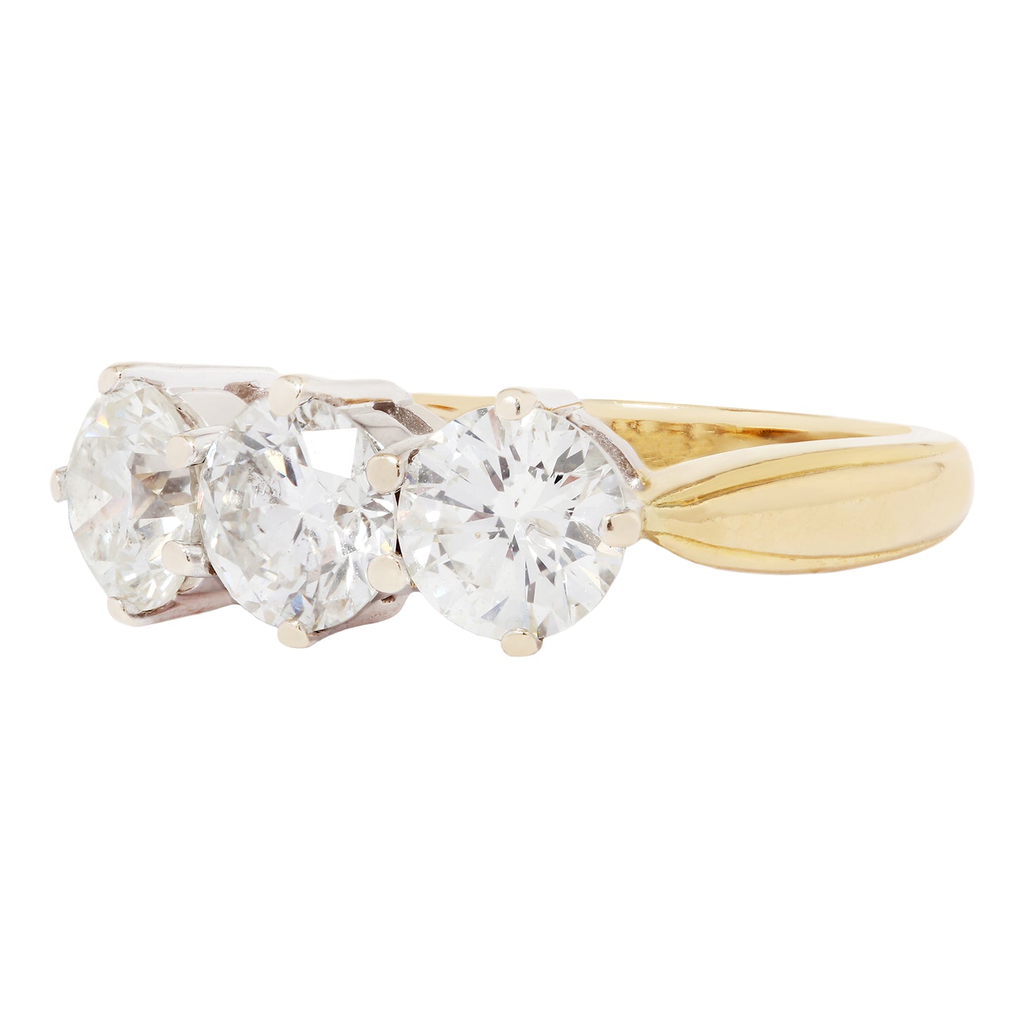 Gold ring with three clear gemstones on a white background