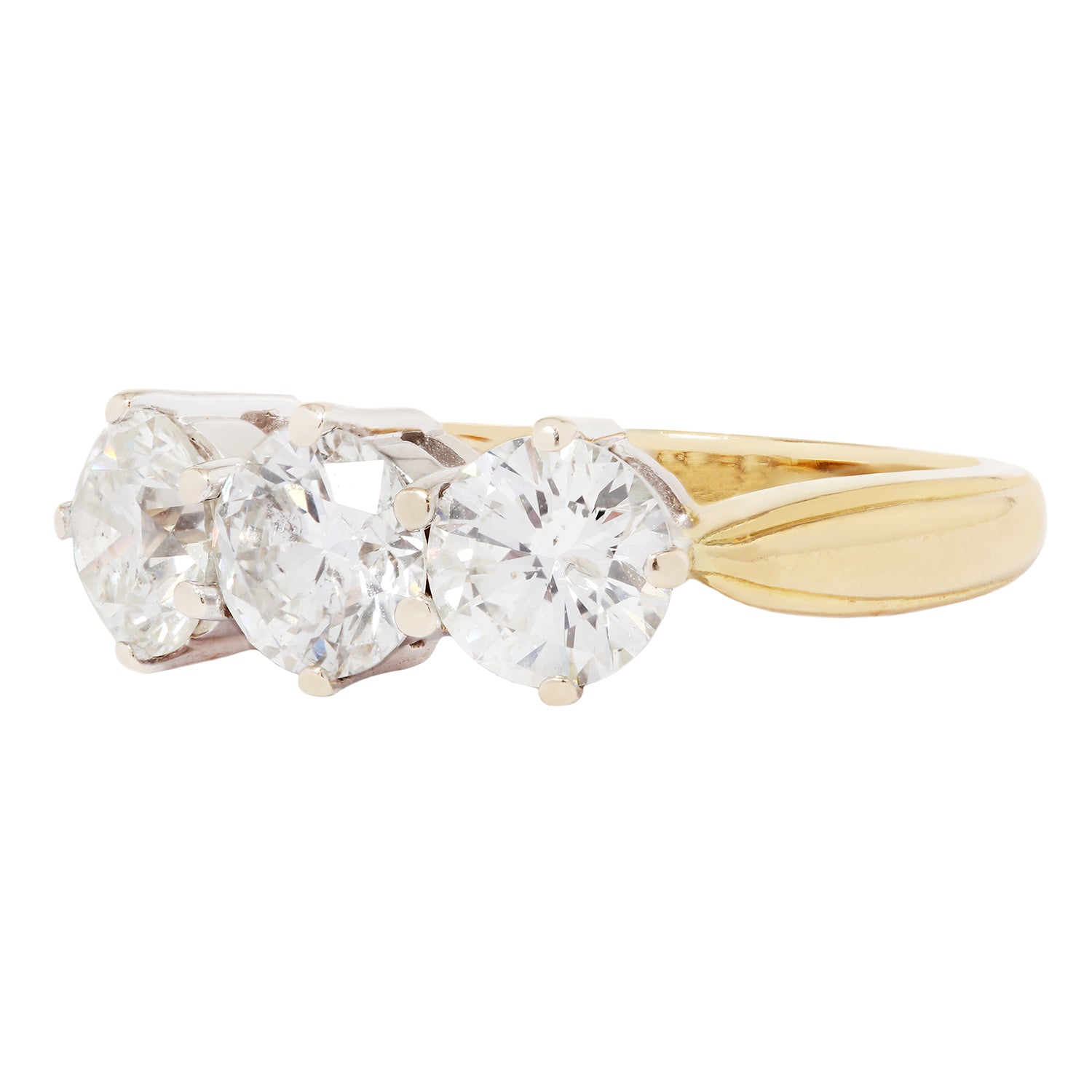 Gold ring with three clear gemstones on a white background