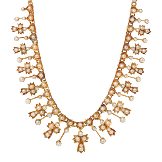 A gold collar necklace adorned with multiple rows of pearls and small star-shaped clusters, shown against a plain white background.