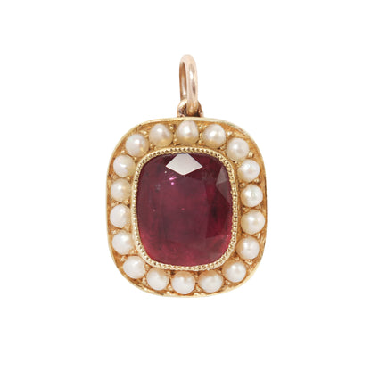 Antique pink red tourmaline and pearl necklace charm on a white background