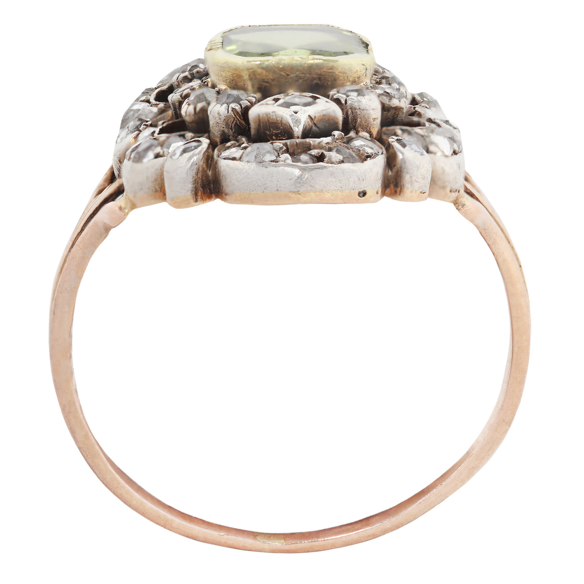 An antique-style ring featuring a rose gold band, a silver-toned floral cluster setting, and a central oval green gemstone, shown against a plain white background.
