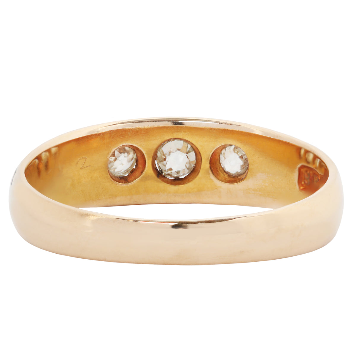 A yellow gold ring featuring three round-cut clear gemstones set in a row on the band, photographed against a plain white background.