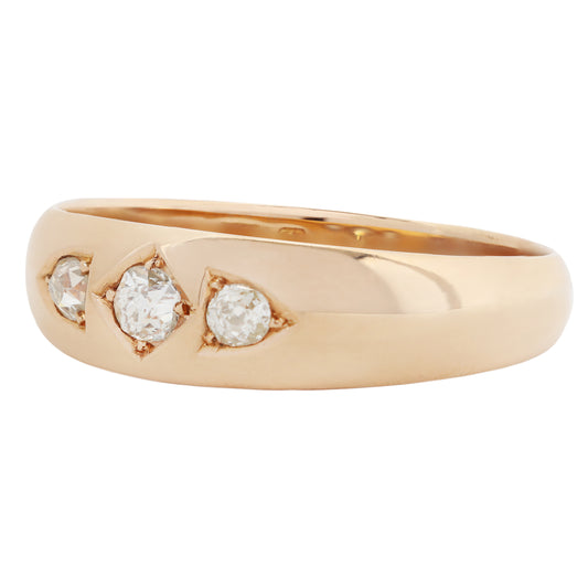 A gold ring featuring three round-cut diamonds set in a curved row, shown on a plain white background.