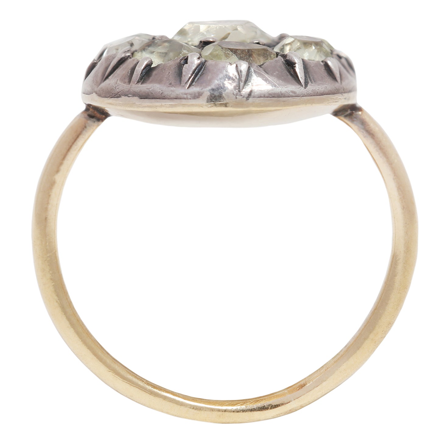 Antique ring with central gemstone and smaller green stones on a white background
