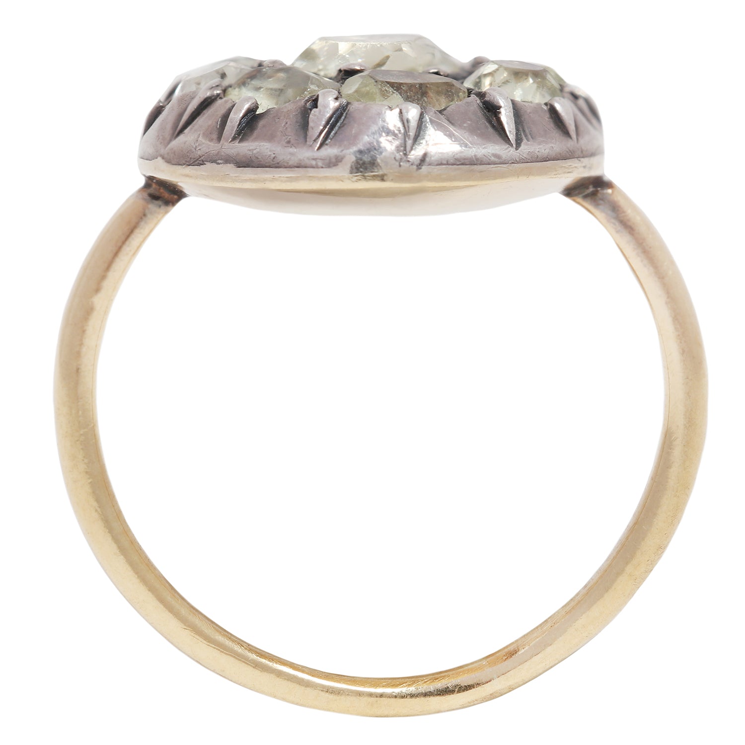 Antique ring with central gemstone and smaller green stones on a white background
