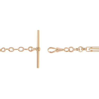 Close-up of a gold-tone chain bracelet showing a toggle clasp on the left and a dog clip clasp with extension links on the right, set against a plain white background.