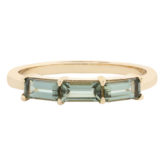A yellow gold ring featuring three rectangular baguette-cut light blue-green gemstones in a prong setting, shown against a plain white background.