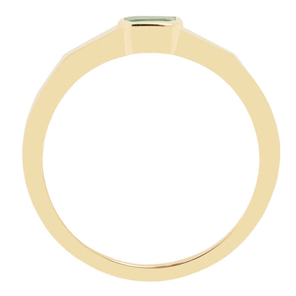 Gold ring with a green gemstone on a white background