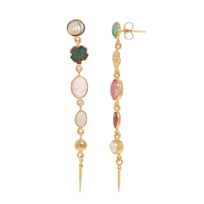 A pair of gold dangle earrings featuring a variety of colorful stones and charms, including a green clover, pink and white oval stones, and a pearl, shown against a plain white background.