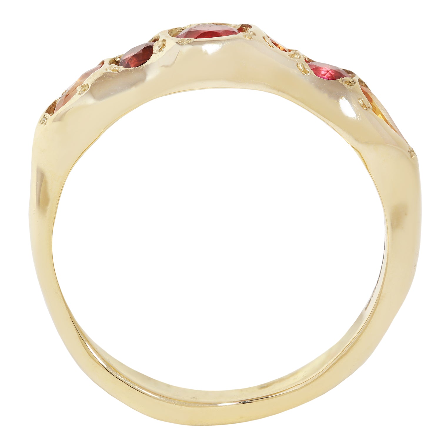 A yellow gold ring with a wide, polished band featuring a row of small red gemstones set along the top, shown against a plain white background.