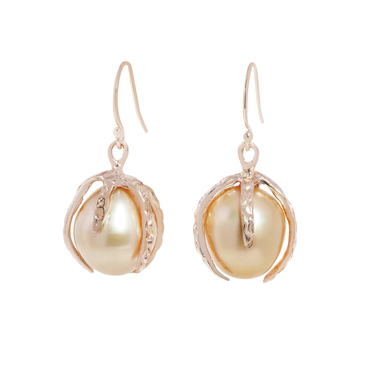 A pair of gold drop earrings featuring large, lustrous baroque pearls nestled in textured, claw-like gold settings, shown against a plain white background.