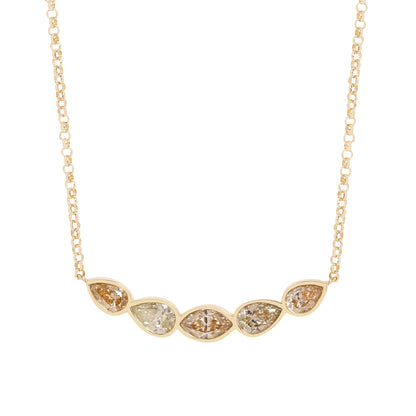 A gold chain necklace featuring five Marquise and pear shape diamonds in a row, with three diamonds showing warm brownish tones and two showing a pale yellowish hue, set against a plain white background.