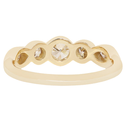 A yellow gold ring with a scalloped five-stone setting, featuring a central round clear gemstone and four smaller round clear gemstones, shown on a plain white background.