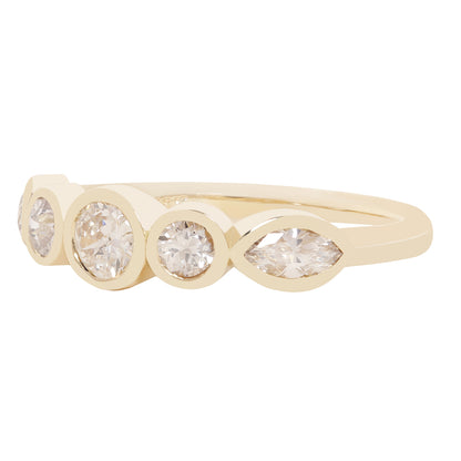 A yellow gold ring featuring four marquise-cut clear gemstones in bezel settings, displayed on a clean white background.