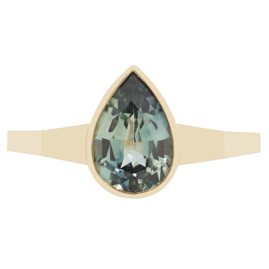 Gold ring with a green teardrop-shaped gemstone on a white background