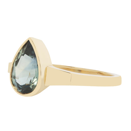 Gold ring with a green gemstone on a white background