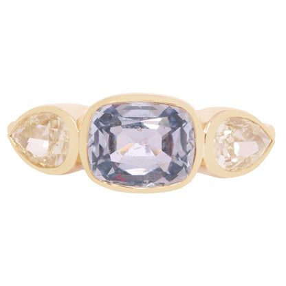 Lauren Wolf - Gold ring with three gemstones on a white background