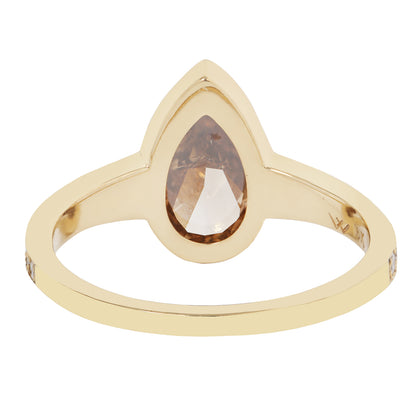 Gold ring with a pear-shaped gemstone on a white background