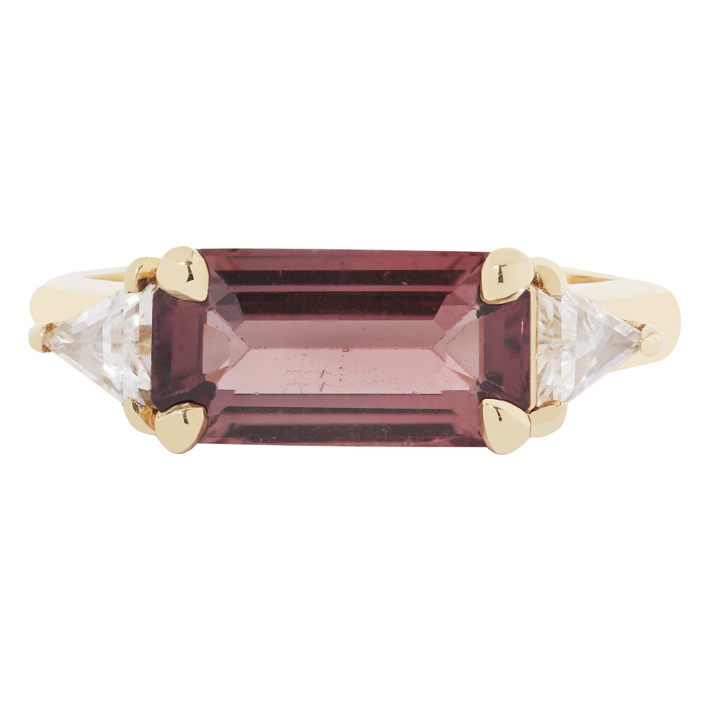 Gold ring with a maroon gemstone and clear stones on a white background
