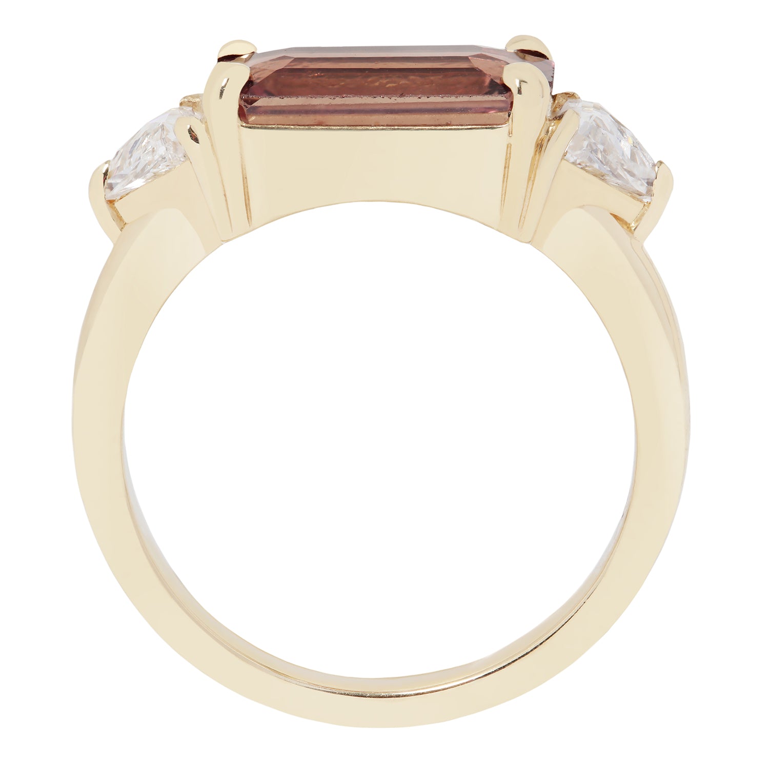Gold ring with a central maroon gemstone and two smaller clear stones on a white background