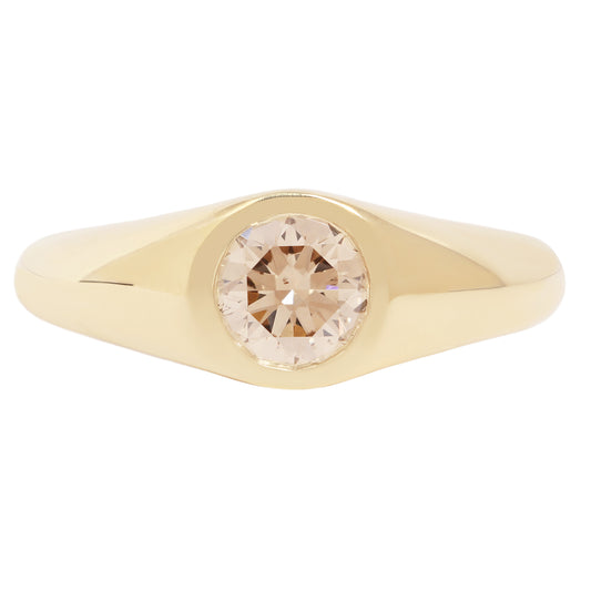 Lauren Wolf - Gold ring with a round diamond on a white background